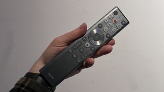 Hisense U9N TV remote control held in hand