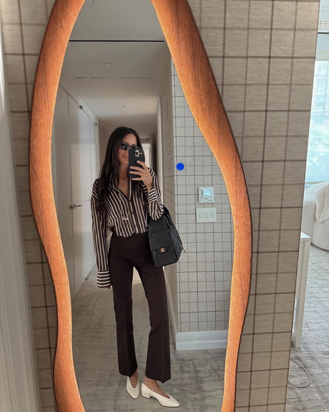 Arielle Charnas wears cut flared pants