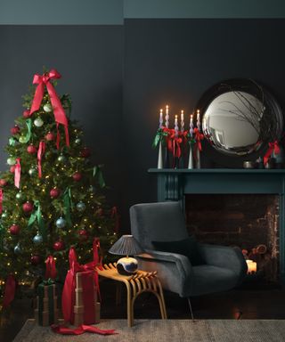 living room with dark blue walls, dark green fireplace, Christmas tree and cozy decor