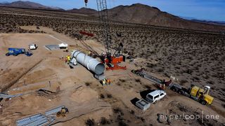 Engineers install the first tube for the Hyperloop One project's test track in the Nevada desert.