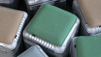 RIMOWA x Vitra collaboration suitcase stools with green and tan cushions