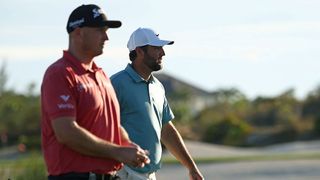 Sepp Straka, in a red shirt, and Scottie Scheffler, in a teal shirt, walk together during their excellent third rounds at the Hero World Challenge 2025 golf tournament in the Bahamas