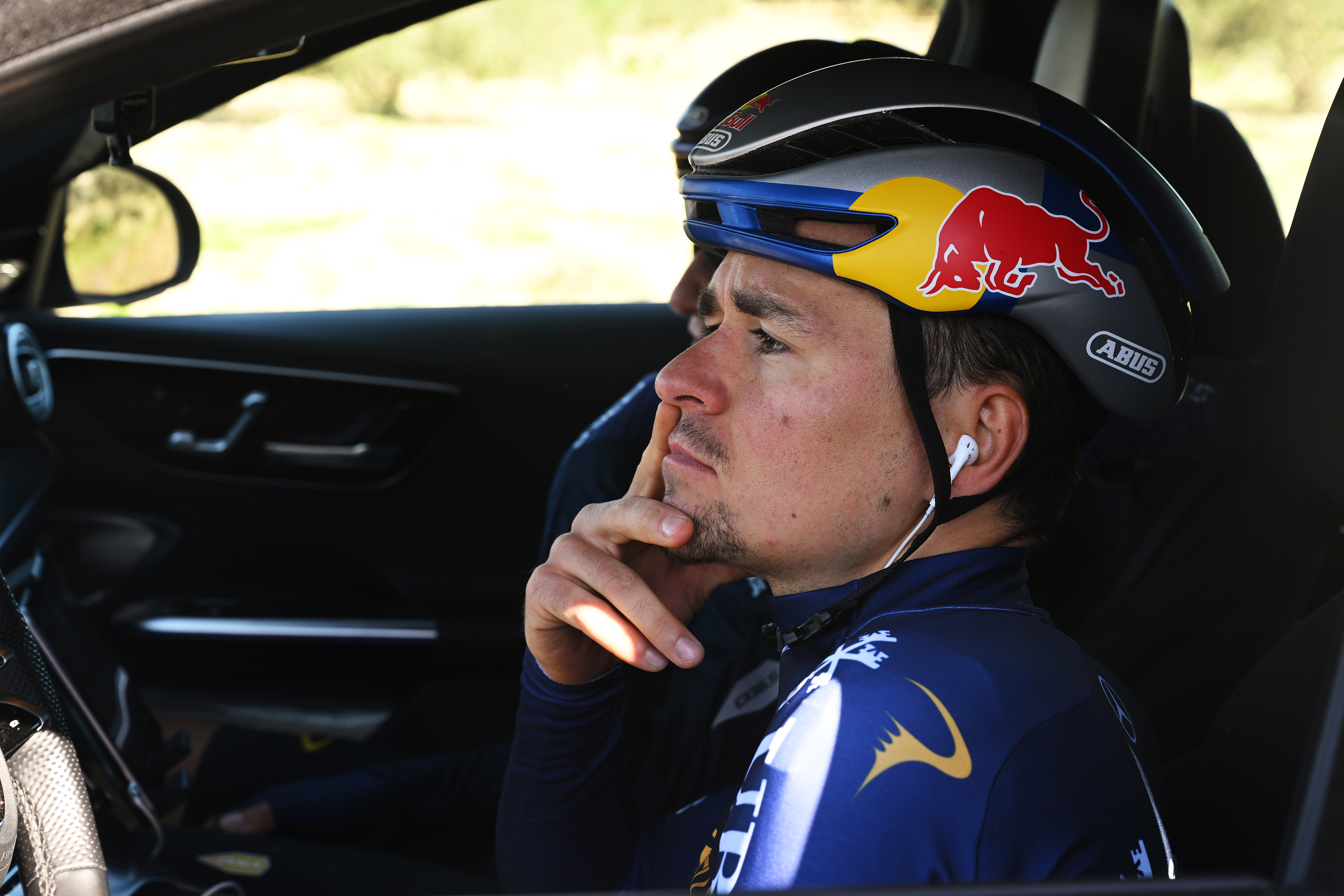 Tom Pidcock in driving seat of a team car