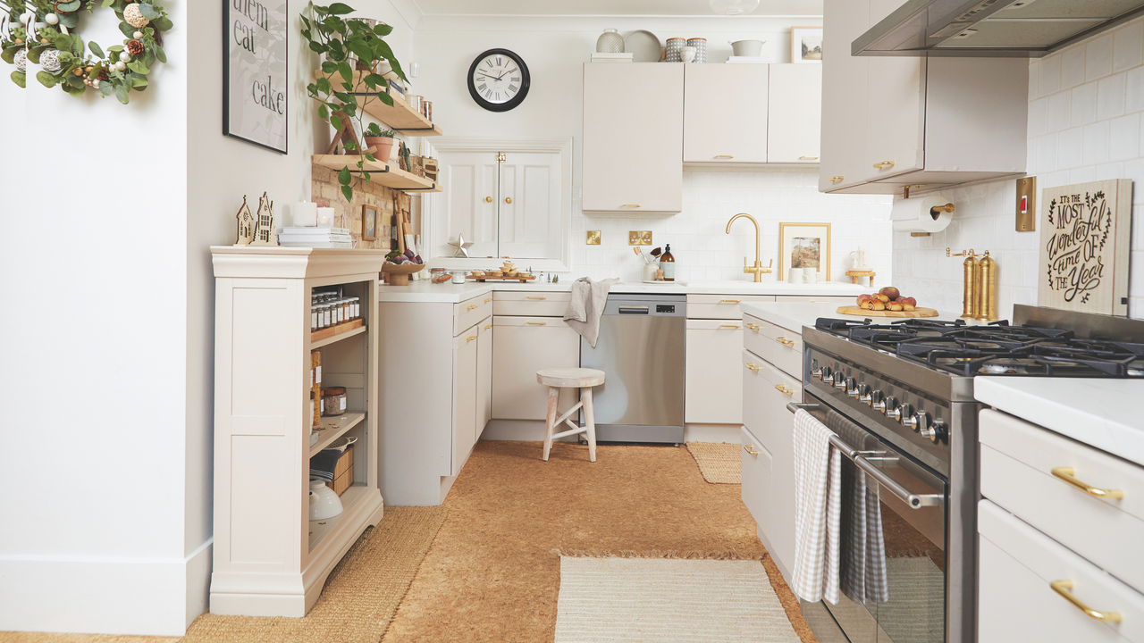 A view of a white, mordern kitchen, featuring a modern glass door oven.