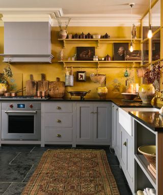 gray kitchen cabinets with yellow walls by devol kitchens
