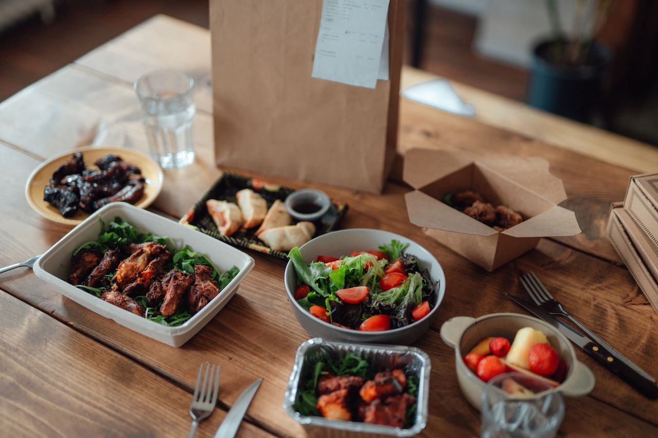 a table with take away meals in trays