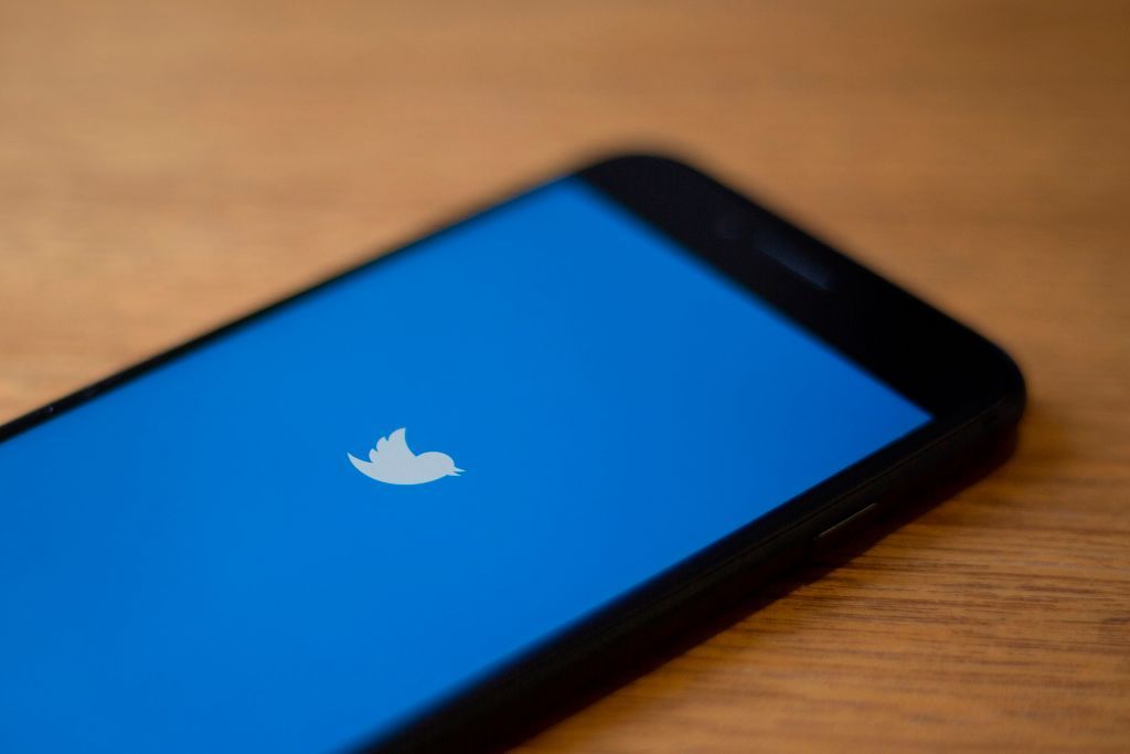 The Twitter logo is seen on a phone in this photo illustration in Washington, DC, on July 10, 2019