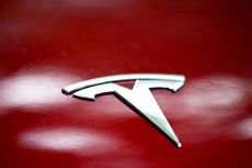 Tesla logo on the body of car parked in Warsaw