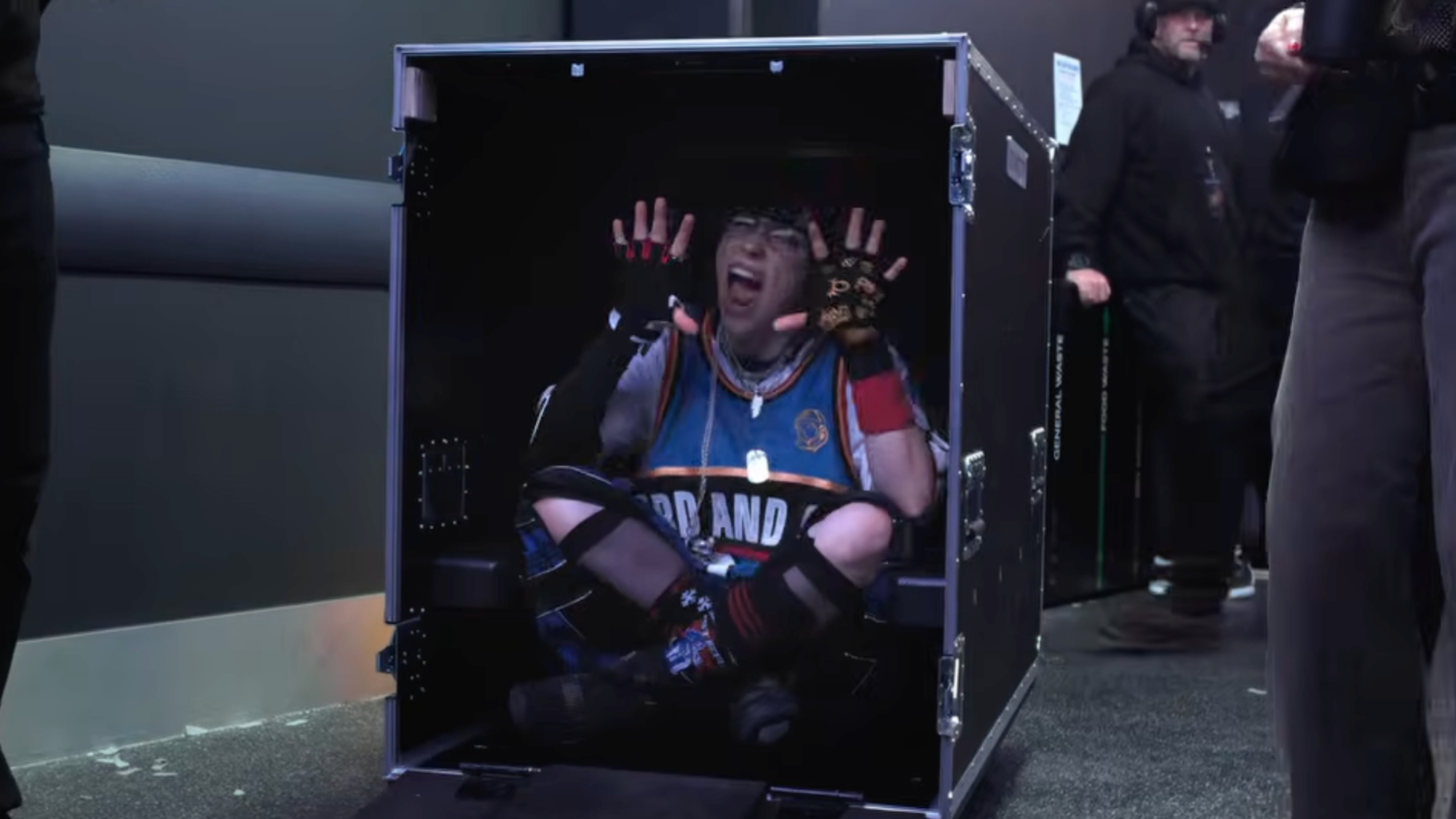 Still of Billie Elish inside a packing case