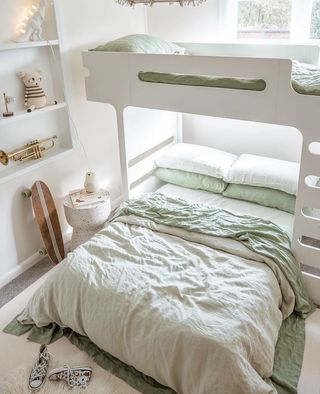 White lofted bed with green sheets