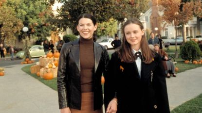 lorelei and rory walk through the stars hollow square as it&#039;s set up for fall in gilmore girls