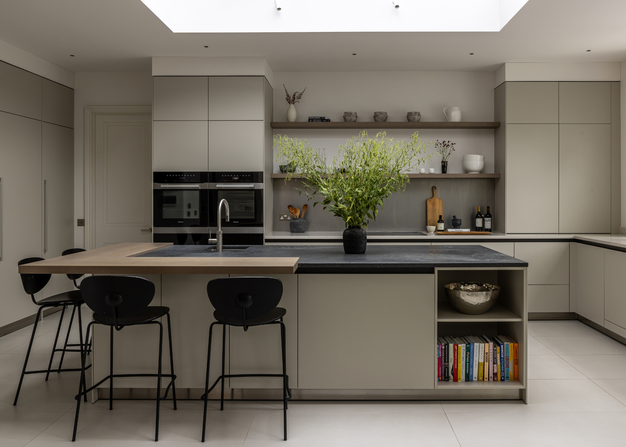 modern kitchen with soft, warm grey cabinetry and a big skylight above the island