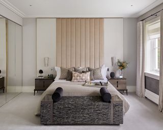 Bedroom carpet ideas with neutral carpet in neutral room with statement upholstered headboard