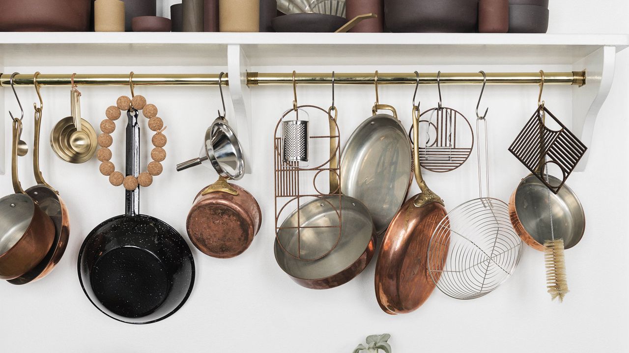 ways to organize pots and pans rustic copper pots and pans hanging on a gold rail in a white kitchen 