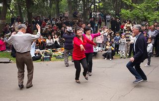 Michael Palin dancing with North Korean residents at the May Day parade