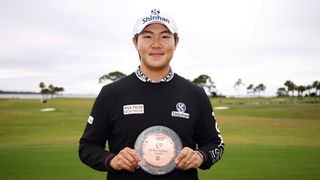 Seonghyeon Kim with the Korn Ferry Tour Rookie of the Year trophy