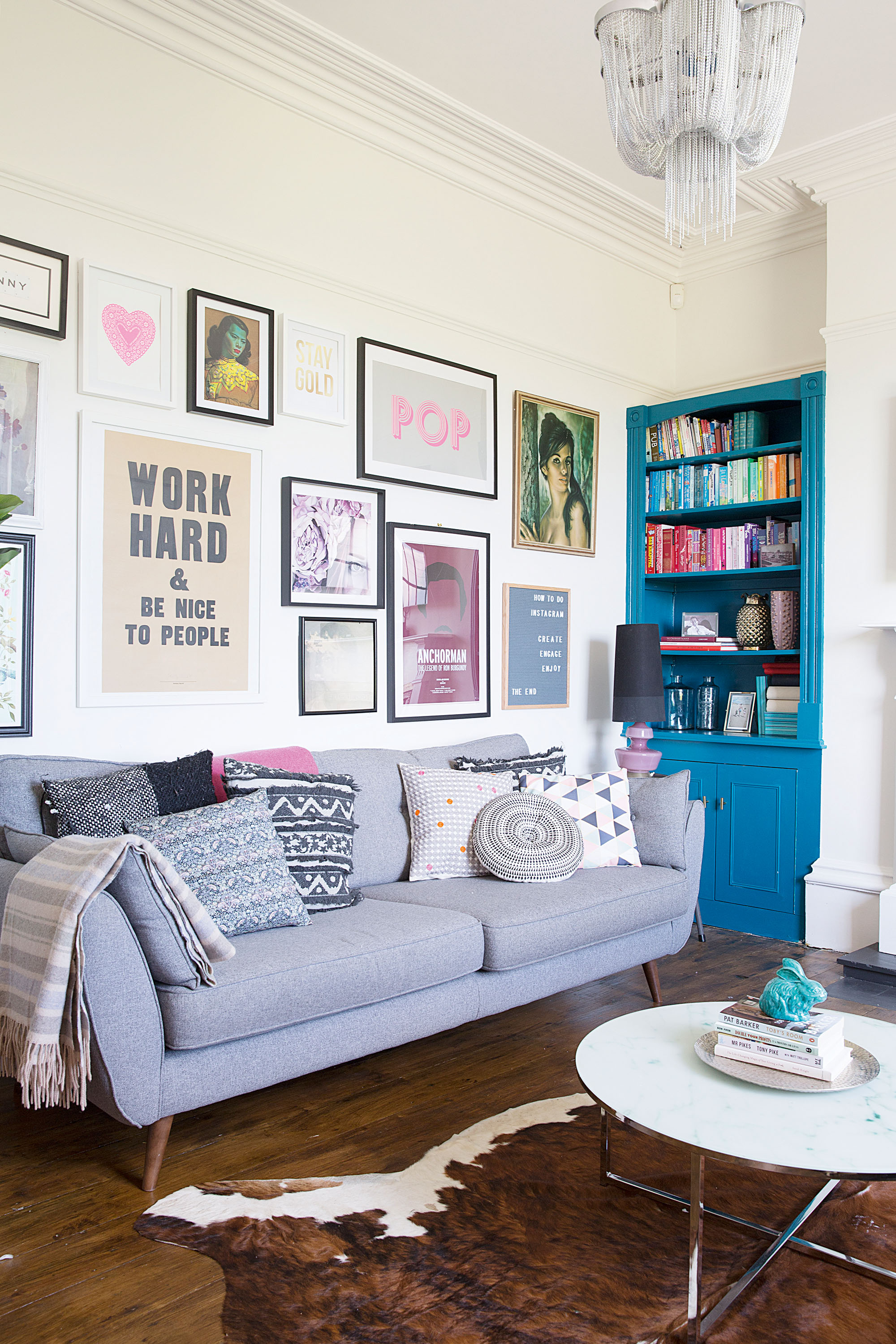 Living room with grey sofa, a gallery wall and built-in dresser