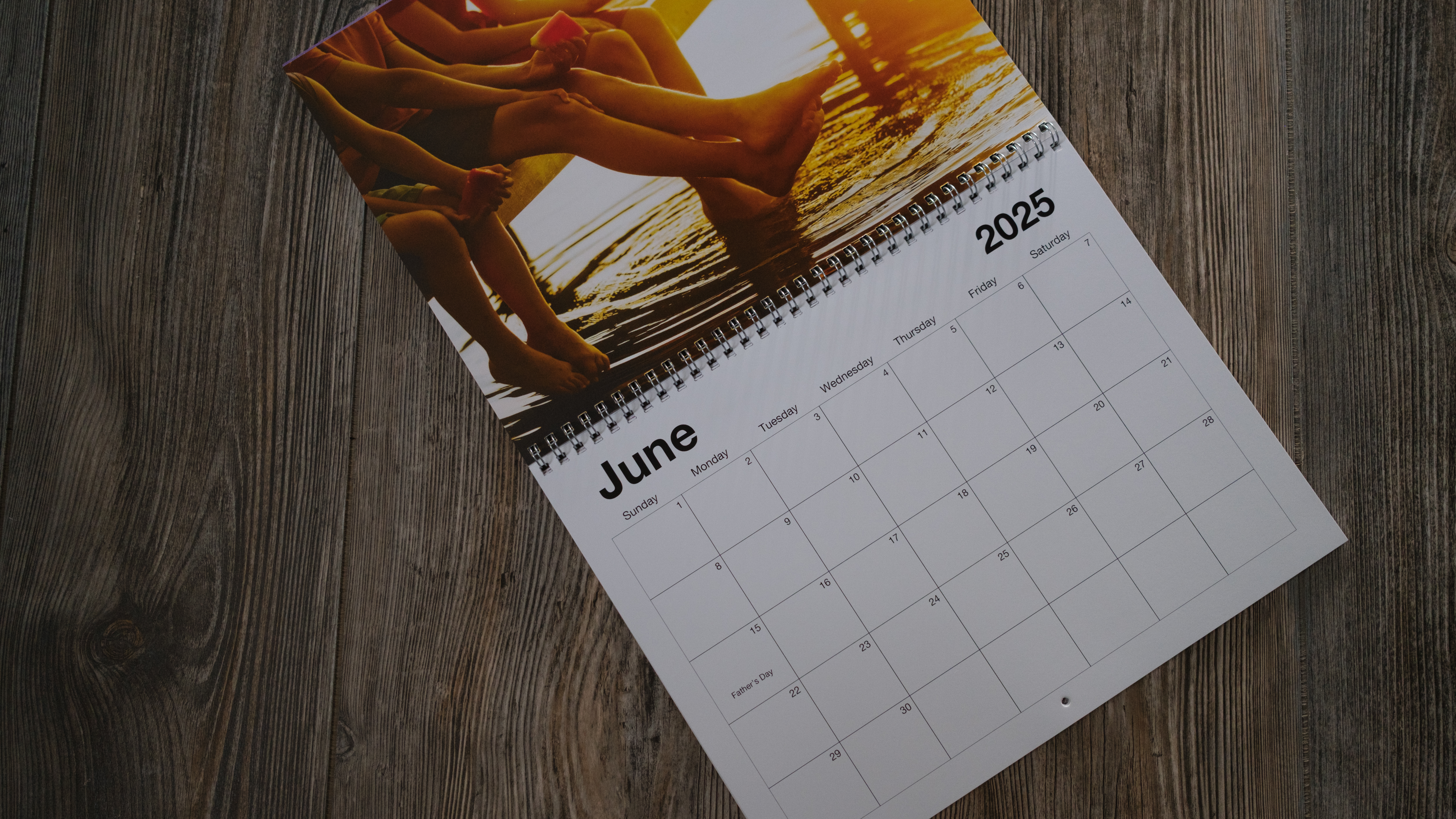 A photo calendar from Shutterfly on a wood background