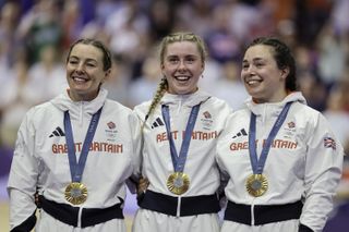 Katy Marchant, Sophie Capewell, Emma Finucane on the podium receiving the Olympic Gold Medal after winning the Women's Team Sprint to become Olympic Champions