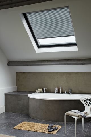 Roof blinds in a loft conversion bathroom by Luxaflex