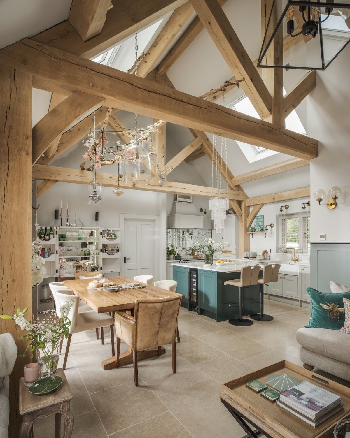 The interior of an oak frame home with exposed beams and modern country furnishings