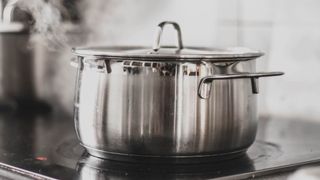 stainless steel pan boiling on hob