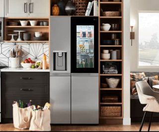 A modern kitchen with storage shelves and a fridge