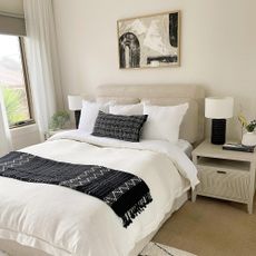 monochrome bedroom with bed and bedside lamps