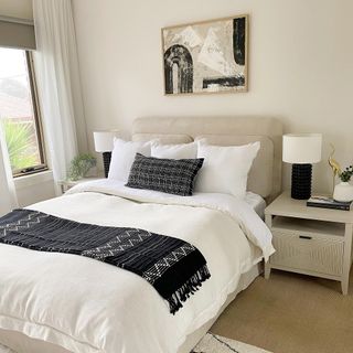 monochrome bedroom with bed and bedside lamps