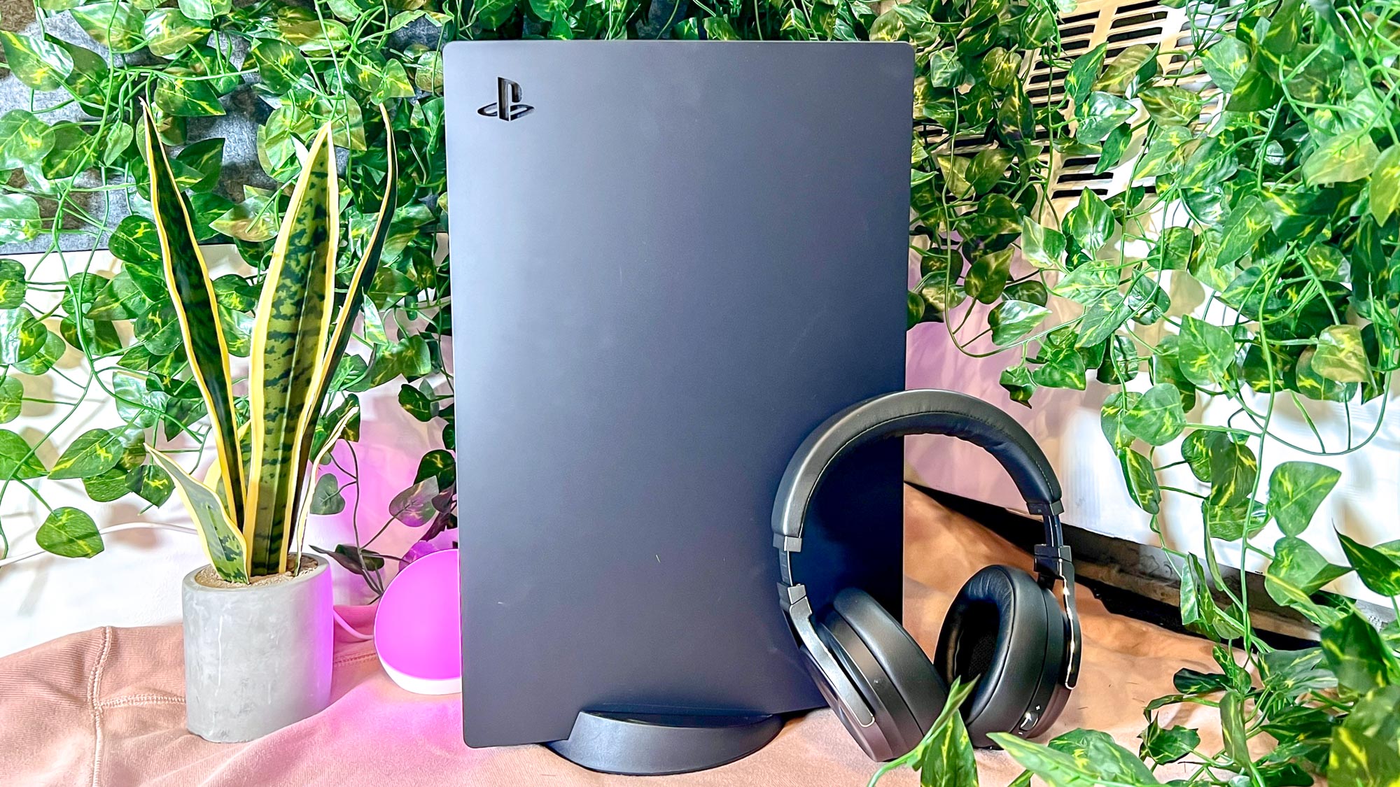 PS5 console with Midnight Black cover, with earphones