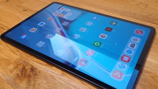 Huawei Matepad 11 review, a photo of a drawing tablet showing apps on a wooden table