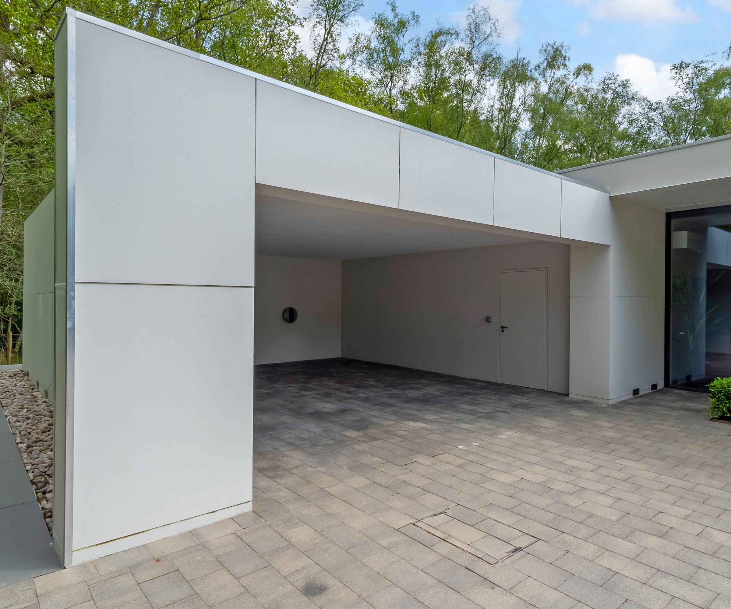 A garage with a block paving driveway