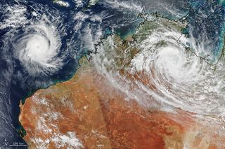 Tropical cyclones Ferdinand and Esther swirl over Australia in this satellite image from the NASA-NOAA Suomi NPP weather satellite. This image combines data that Suomi NPP collected as it passed over Australia twice on Monday (Feb. 24). The diagonal line marks the edge of the swath between the two satellite passes, which occurred about 90 minutes apart. Esther made landfall near Queensland on Monday and has since been downgraded to a tropical storm. Ferdinand, seen here off the northwest coast of Australia, formed over the weekend and is now a Category 2 storm, but it is not expected to make landfall.