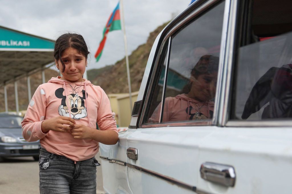 A refugee child cries at the border of Nagorno-Karabakh