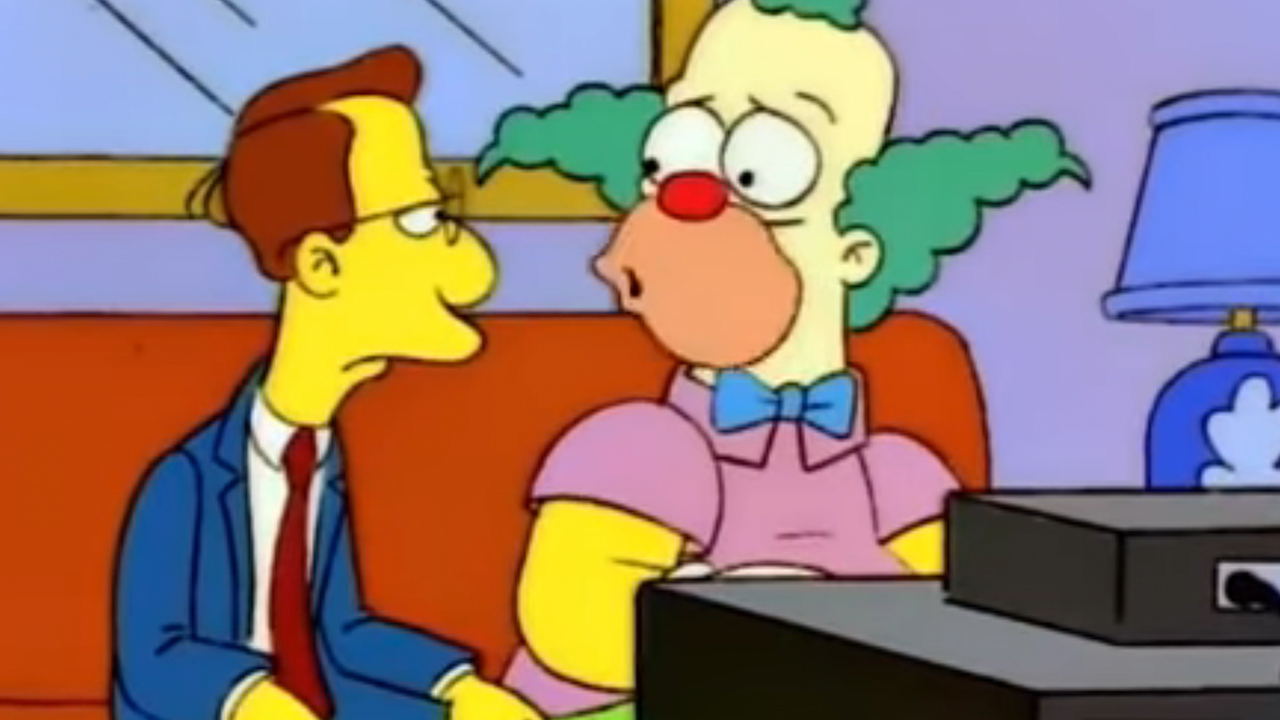 Krusty The Clown looking worried while talking to his accountant.