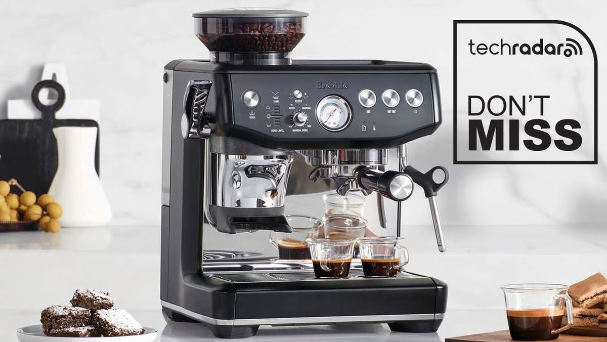 Breville Barista Express Impress coffee machine in truffle black, sitting on kitchen counter. TechRadar logo and &quot;Don&#039;t Miss&quot; text are in black in the top right corner.