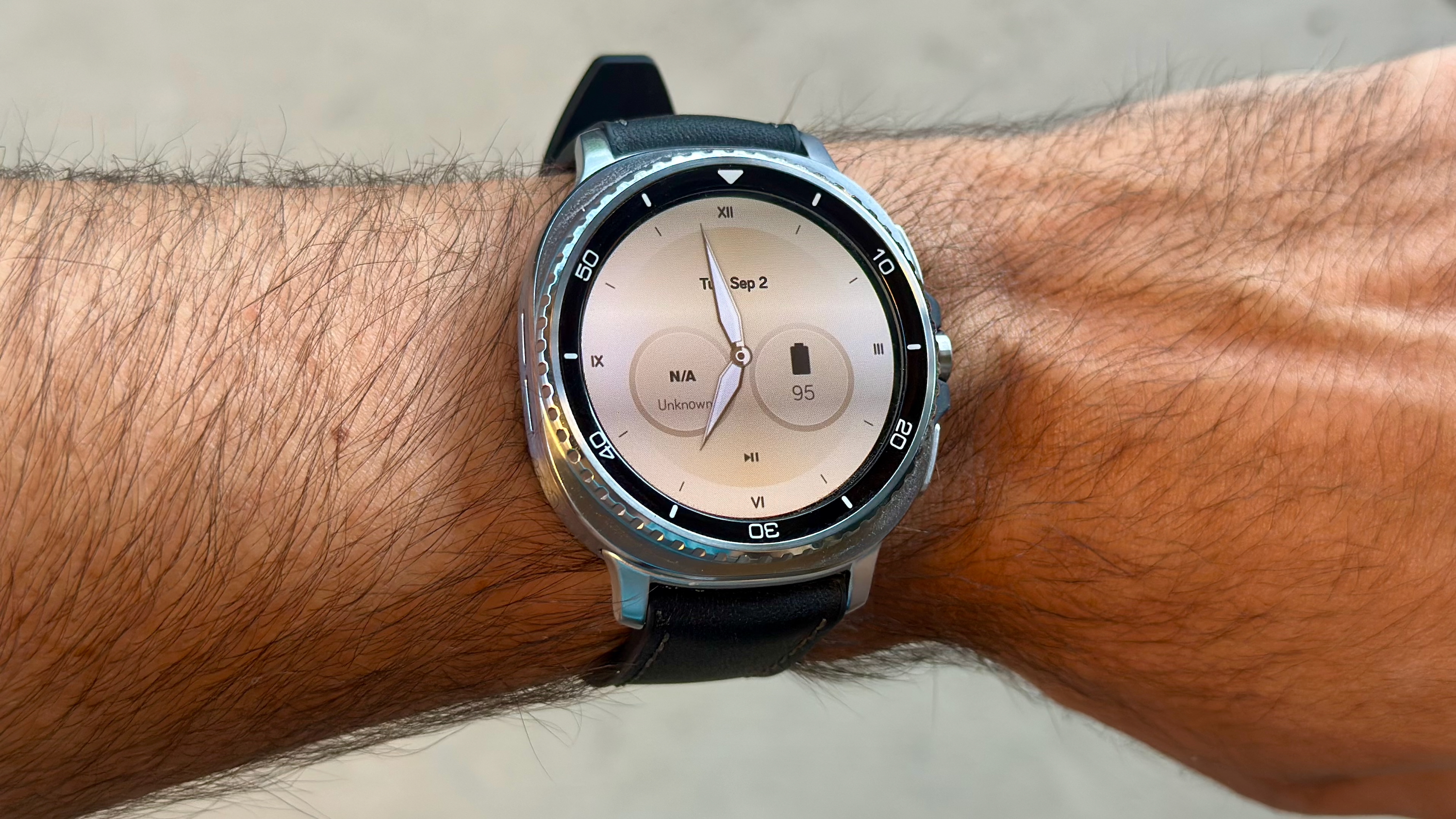 The Samsung Galaxy Watch 8 Classic on a person's wrist, showing a custom watch face from the Pujie app called "Goldfinger."