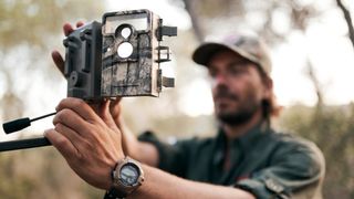 man using a trail camera