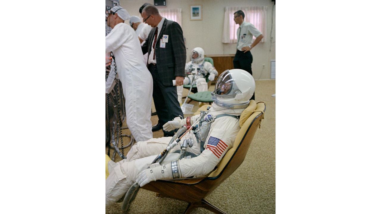 The crew for NASA's Gemini 10 mission, astronauts Michael Collins (foreground) and John W. Young (background) suit up for launch.