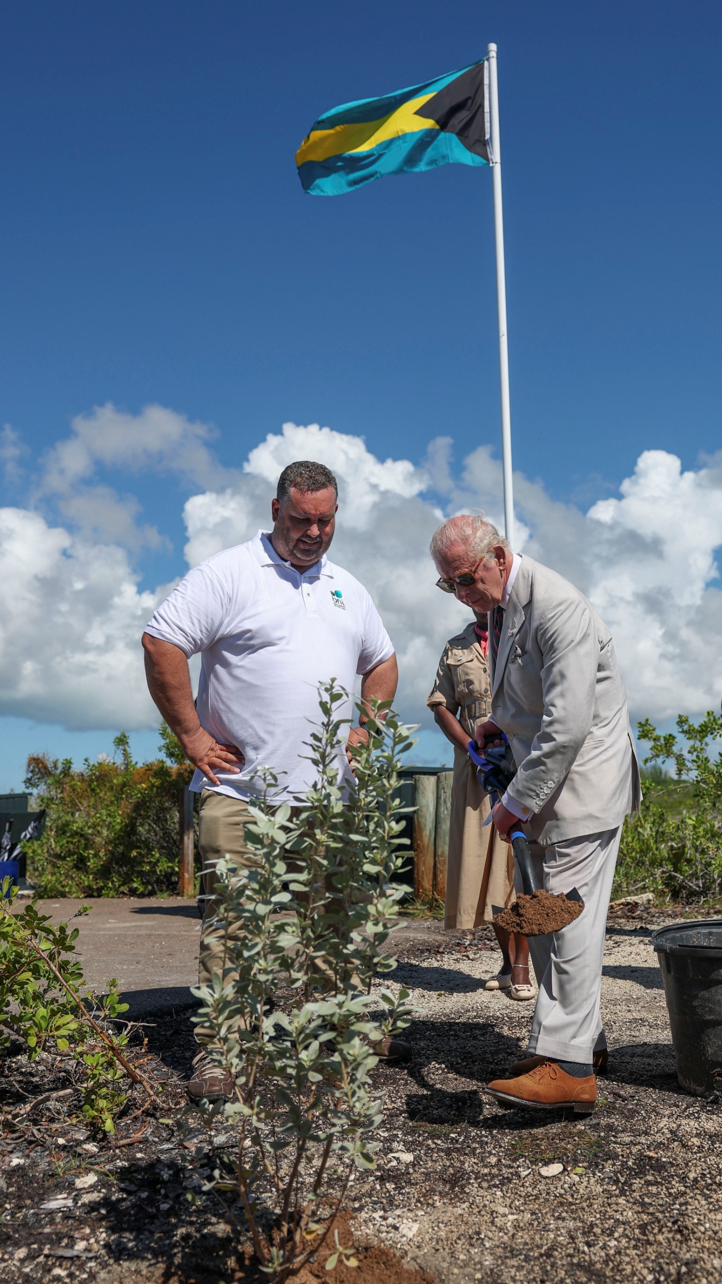 Britain's King Charles III plants a silver buttonwood tree at Bonefish Pond National Park in New Providence as part of the autumn tour of Caribbean nations on October 28, 2026 in Nassau, Bahamas