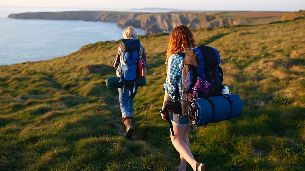 Two female hikers by the coast