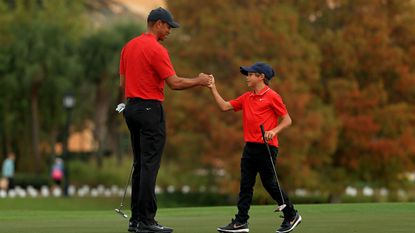 Tiger and Charlie Woods fist bump