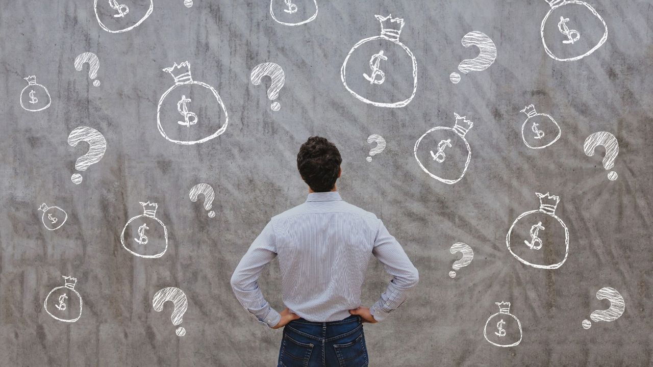 Man looking up at a big chalkboard with drawings of question marks and bags with dollar signs on them