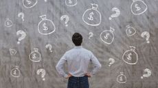 Man looking up at a big chalkboard with drawings of question marks and bags with dollar signs on them