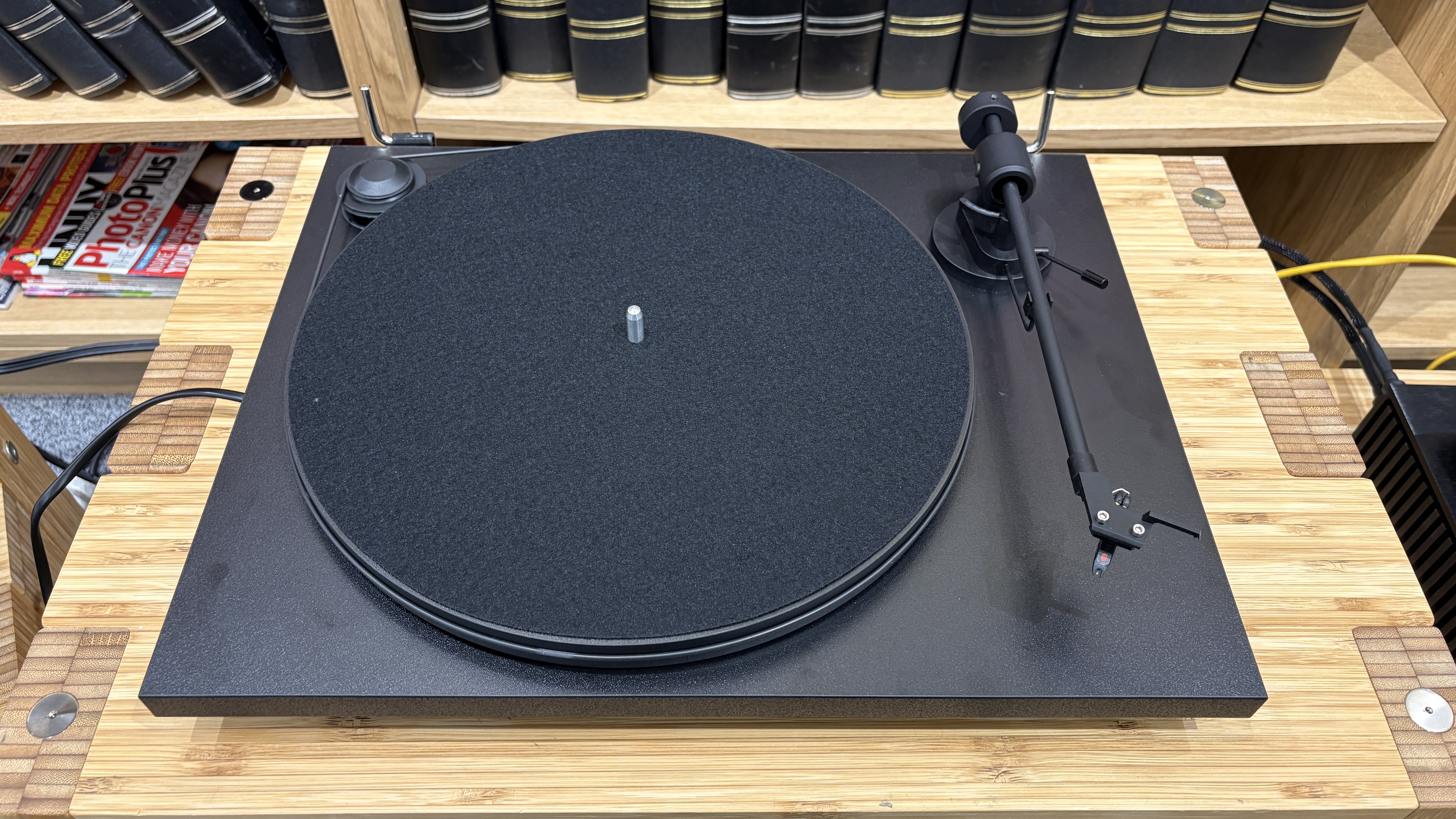 Pro-Ject Primary E turntable on wooden rack