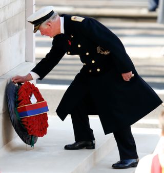 Prince Charles, Prince of Wales lays a wreath on behalf of Queen Elizabeth II during the annual Remembrance Sunday service at The Cenotaph