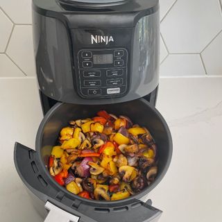 Cooked vegetables in the basket of the Ninja AF100UK Air Fryer
