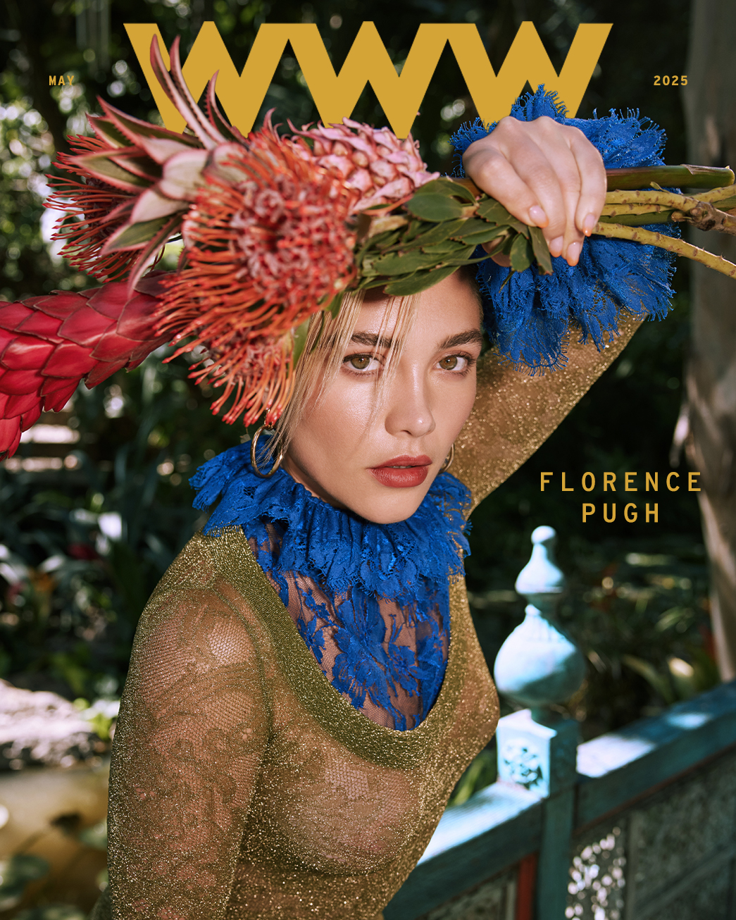Florence Pugh cover for Who What Wear. She is wearing a sheer lace Saint Laurent dress with blue collar and sleeve detailing. She is holding tropical flowers over her head.