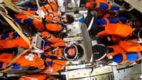 Artemis 2 astronauts loaded into their capsule.