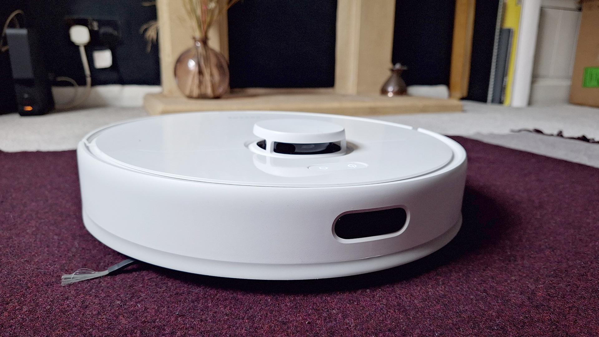 Dreame D9 Max Gen 2 robot vacuum in front of fireplace in reviewer's home